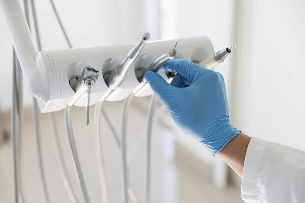 Professional Tooth Extraction technician working in Russellville, AL